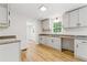 Bright kitchen features modern cabinetry, granite countertops, and hardwood floors at 2868 Wood Park Nw Trce, Kennesaw, GA 30152