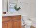 This bathroom features a white basin, toilet, and light wood cabinets at 3516 Waldrop Trl, Decatur, GA 30034
