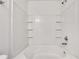 This bathroom features a white tub with white tile surround at 3516 Waldrop Trl, Decatur, GA 30034