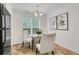 Bright dining area with a glass table, white chairs, and large window, perfect for gatherings at 3516 Waldrop Trl, Decatur, GA 30034