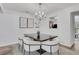 Bright dining area with modern lighting and a peek into the cozy kitchen space at 3516 Waldrop Trl, Decatur, GA 30034