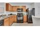 Efficient kitchen with dark appliances, wooden cabinets, and laminate countertops at 3516 Waldrop Trl, Decatur, GA 30034