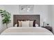 Tastefully decorated main bedroom featuring a statement headboard, pillows, and side table at 3516 Waldrop Trl, Decatur, GA 30034