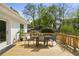 Inviting deck with a dining table, seating area, and a view of the landscaped backyard at 102 Rockyford, Atlanta, GA 30317