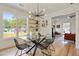 Dining area features a modern glass table, designer lighting, and views to the exterior at 102 Rockyford, Atlanta, GA 30317