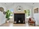 Modern fireplace with black brick surround and light wood mantel, flanked by windows and decorative elements at 102 Rockyford, Atlanta, GA 30317