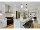 Modern kitchen featuring white cabinets, stainless steel appliances, quartz countertops, and a breakfast bar with seating at 102 Rockyford, Atlanta, GA 30317