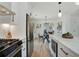 Open kitchen with a breakfast bar, stainless steel appliances, and a view to the adjacent dining and living area at 102 Rockyford, Atlanta, GA 30317