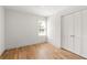 Cozy bedroom with hardwood floors, white walls, and a large closet at 126 Marona Ne St, Atlanta, GA 30307