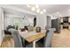 Open concept dining room with modern lighting and view of the living room and updated kitchen at 126 Marona Ne St, Atlanta, GA 30307