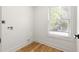 Clean laundry room with hardwood floors, utility connections, and natural light at 126 Marona Ne St, Atlanta, GA 30307
