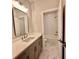 Bathroom featuring large mirror, quartz countertop vanity, and tiled shower/bath at 285 Briscoe Way # 2, Alpharetta, GA 30009