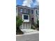 Beautiful brick townhome featuring a two-car garage, elegant black trim, and a cozy, covered entryway at 285 Briscoe Way # 2, Alpharetta, GA 30009