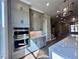 Gourmet kitchen with stainless steel appliances, gray cabinets and large marble countertops at 285 Briscoe Way # 2, Alpharetta, GA 30009