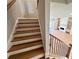 Elegant wooden staircase with white risers and black iron railing, leading to an open-concept living area at 285 Briscoe Way # 2, Alpharetta, GA 30009
