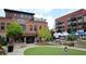 Lively town square with brick buildings, green spaces, and people enjoying a sunny day at 285 Briscoe Way # 2, Alpharetta, GA 30009