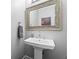 Bathroom features a pedestal sink with a decorative mirror and gray walls at 4030 River Ridge Se, Marietta, GA 30067