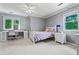 Cozy bedroom featuring two windows, a ceiling fan, and a workspace with a white desk and chair at 4030 River Ridge Se, Marietta, GA 30067