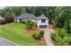 Beautiful two-story home with a well-manicured lawn and mature trees offering great curb appeal at 4030 River Ridge Se, Marietta, GA 30067