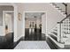 Welcoming foyer with dark hardwood floors, a staircase with white spindles, and an open view to the living spaces at 4030 River Ridge Se, Marietta, GA 30067