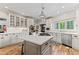 Well-lit kitchen with a center island, white cabinets, stainless steel appliances, and subway tile backsplash at 4030 River Ridge Se, Marietta, GA 30067