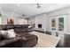 Large living room featuring dark wood floors, a stone fireplace, and doors leading to the outdoor patio at 4030 River Ridge Se, Marietta, GA 30067