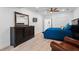 Main bedroom with wood-look flooring, dresser, ceiling fan and access to the ensuite bathroom at 4030 River Ridge Se, Marietta, GA 30067