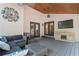 The covered patio has comfortable seating, a ceiling fan, and a tv for relaxation and entertainment at 4030 River Ridge Se, Marietta, GA 30067