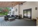 Covered patio with cozy furniture, mini fridge, and beautiful wood ceiling is an inviting extension of the home at 4030 River Ridge Se, Marietta, GA 30067
