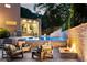 Beautiful backyard with outdoor kitchen, dining, pool, fire pit and lovely lounge seating at 1242 Wild Creek Ne Trl, Atlanta, GA 30324