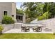 Beautiful backyard with lounge seating, fire pit and lush lawn and gardens at 1242 Wild Creek Ne Trl, Atlanta, GA 30324