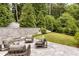 Beautiful backyard with lounge seating, fire pit and lush lawn and gardens at 1242 Wild Creek Ne Trl, Atlanta, GA 30324