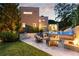 Landscaped backyard with a pool, fire pit, and outdoor seating area at 1242 Wild Creek Ne Trl, Atlanta, GA 30324