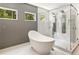Bathroom featuring a modern soaking tub, walk-in shower, and bright windows at 1242 Wild Creek Ne Trl, Atlanta, GA 30324