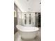 Modern bathroom featuring a soaking tub and dual shower heads behind a glass enclosure at 1242 Wild Creek Ne Trl, Atlanta, GA 30324