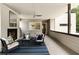 Relaxing covered patio with fireplace, ceiling fan, seating, and a tranquil outdoor view at 1242 Wild Creek Ne Trl, Atlanta, GA 30324