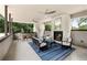 Inviting covered patio featuring a fireplace, ceiling fans, and stylish outdoor furniture at 1242 Wild Creek Ne Trl, Atlanta, GA 30324