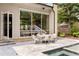 Outdoor dining and lounging area by the pool with lovely backyard views and seamless indoor/outdoor living at 1242 Wild Creek Ne Trl, Atlanta, GA 30324