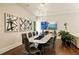 Elegant dining room with modern chandelier, long table set for ten, and stylish artwork on the walls at 1242 Wild Creek Ne Trl, Atlanta, GA 30324