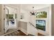 Elegant entryway with modern light fixture, staircase, and access to outdoor deck at 1242 Wild Creek Ne Trl, Atlanta, GA 30324