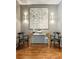 Hallway featuring a mirrored console table, modern art, and two chairs on a wooden floor at 1242 Wild Creek Ne Trl, Atlanta, GA 30324