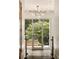 Bright foyer featuring stylish lighting, glass railing and views to the outdoor patio at 1242 Wild Creek Ne Trl, Atlanta, GA 30324