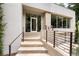 Inviting front entrance with steps leading to a modern glass door, complemented by manicured landscaping at 1242 Wild Creek Ne Trl, Atlanta, GA 30324