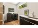 Bright laundry room with modern washer, dryer, sink, and sleek, dark cabinetry at 1242 Wild Creek Ne Trl, Atlanta, GA 30324