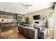 Open-concept living space with kitchen island, modern fireplace, comfortable seating, and natural light at 1242 Wild Creek Ne Trl, Atlanta, GA 30324