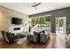 Sophisticated living room with modern fireplace, large windows overlooking the pool, and stylish contemporary decor at 1242 Wild Creek Ne Trl, Atlanta, GA 30324