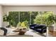 Cozy living room with large windows overlooking lush greenery, accentuated by stylish armchairs and a unique coffee table at 1242 Wild Creek Ne Trl, Atlanta, GA 30324