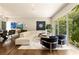 Open-concept living room with hardwood floors, modern furnishings, and expansive windows with outdoor views at 1242 Wild Creek Ne Trl, Atlanta, GA 30324