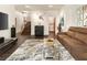 Spacious living room with dark wood floors, stylish decor, a comfortable brown sofa, and a modern glass coffee table at 1242 Wild Creek Ne Trl, Atlanta, GA 30324