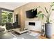 Modern living room showcasing a sleek fireplace, contemporary furnishings, and expansive windows with a view of the outdoors at 1242 Wild Creek Ne Trl, Atlanta, GA 30324